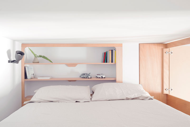 This small studio apartment has a custom designed plywood wall unit that has two sleeping areas and plenty of storage. #SmallApartment #InteriorDesign