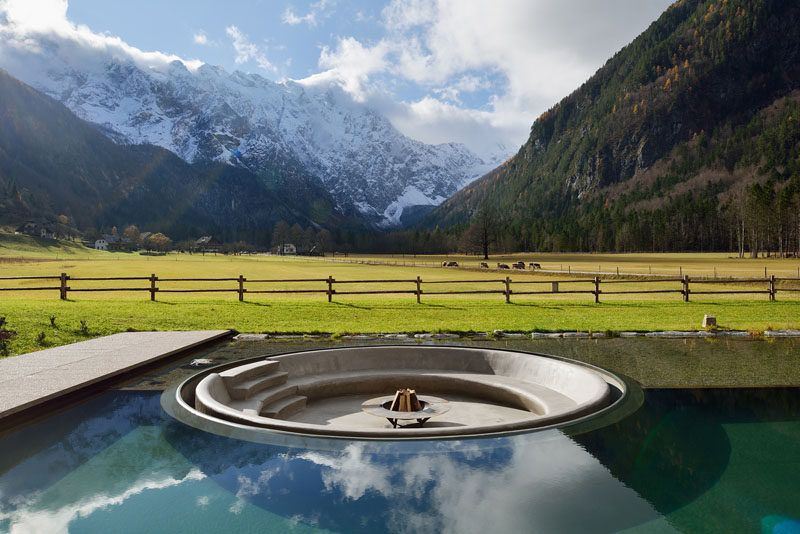 Architecture firm ENOTA have designed a wellness center in Slovenia, and as part of the design, they included a sunken firepit within the swimming pool. #SunkenFirepit #Firepit #SwimmingPool