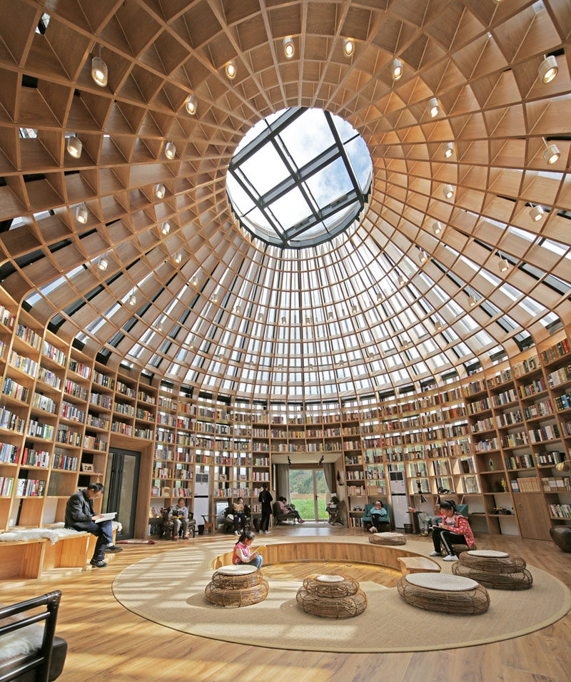 Inside this visitors centre in China, there's a library where local children can visit to read and play. In the middle of the library is a sunken living space, giving visitors a chance to sit and relax. #Library #Architecture #Shelving