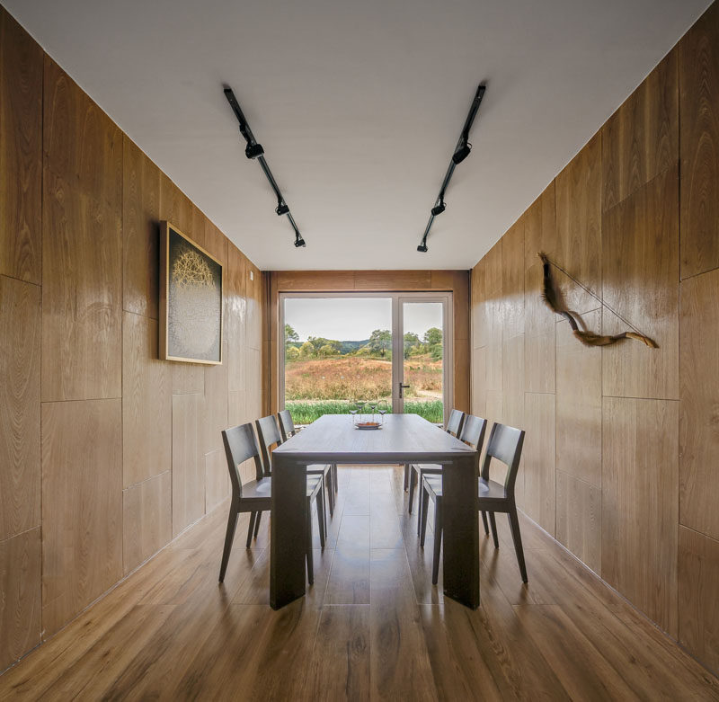 This wood-lined dining area has views of surrounding landscape. #DiningRoom #Wood