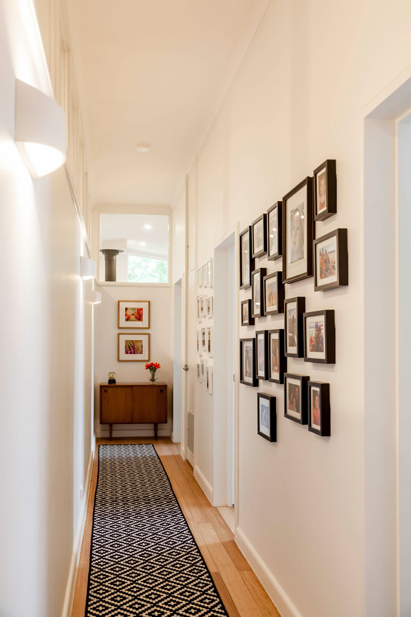 Mid-century modern elements have been kept in this renovated home, like the cabinet at the end of this hallway that leads to the children's bedrooms. #MidCenturyModern #Hallway