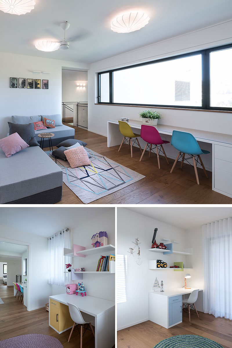 This children's playroom has colorful cushions and a desk that's large enough for three. In the space next to the play area are two additional desks that have been set up as children's work areas. #Playroom #KidsDesks