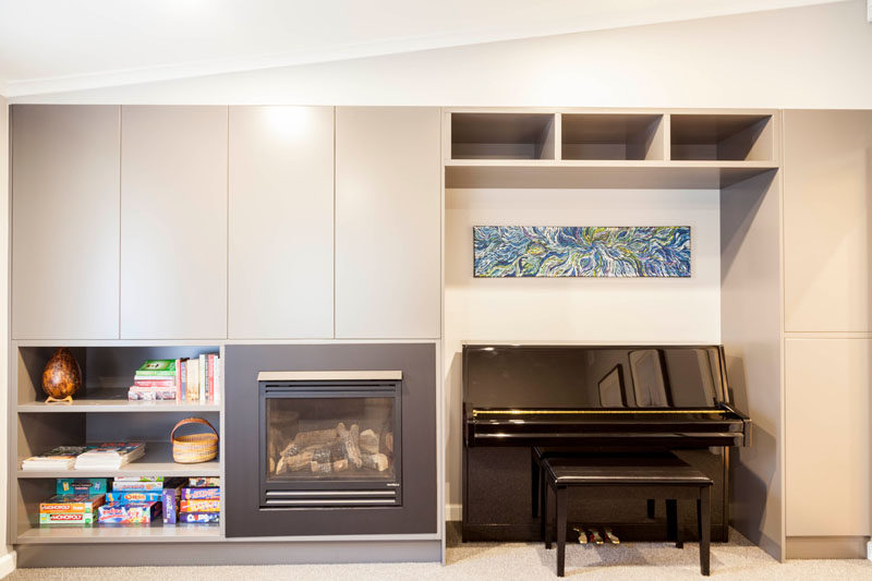 In this contemporary media room, there's built-in joinery to create storage and a gas fireplace adds warmth to the room. #Storage #Fireplace