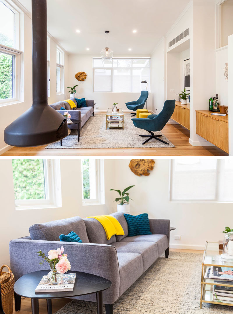 In this contemporary living room, there's a Oblica suspended fireplace, while the furniture is mix of a modern couch and mid-century inspired armchairs. #LivingRoom #InteriorDesign