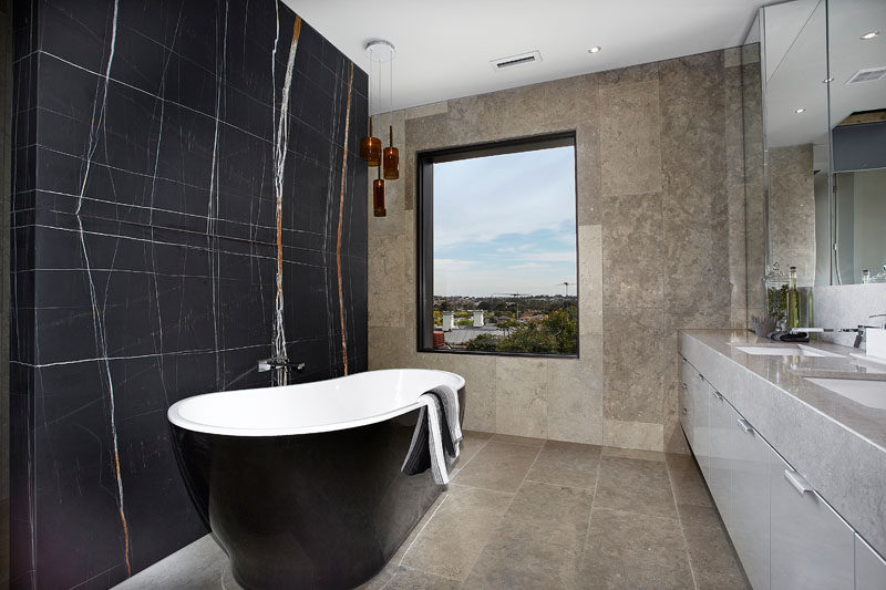 In the master ensuite bathroom there's a freestanding bath tub and double bowl vanity unit. Floor to ceiling marble and stone completes the theme of a luxury hotel retreat. #ModernBathroom