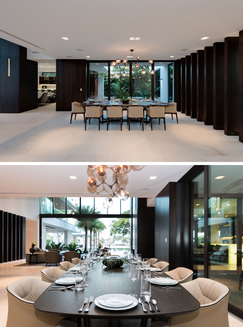 This formal dining area has views of a water feature outside. 