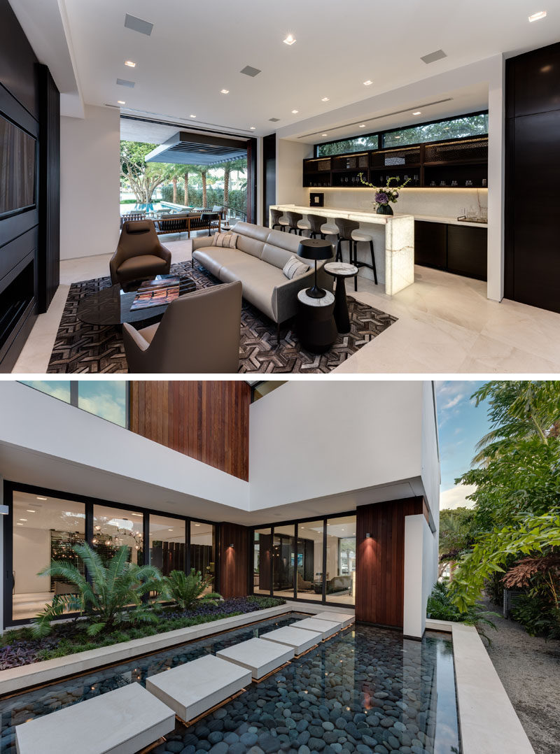 A home bar opens up to the backyard and has views of a reflecting pond.