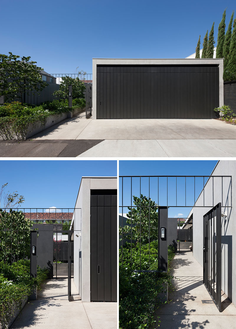 At the front of this modern house, a path sits next to the driveway and garage, and leads past a garden to the entry of the home. #ModernHouse #Garage #Path