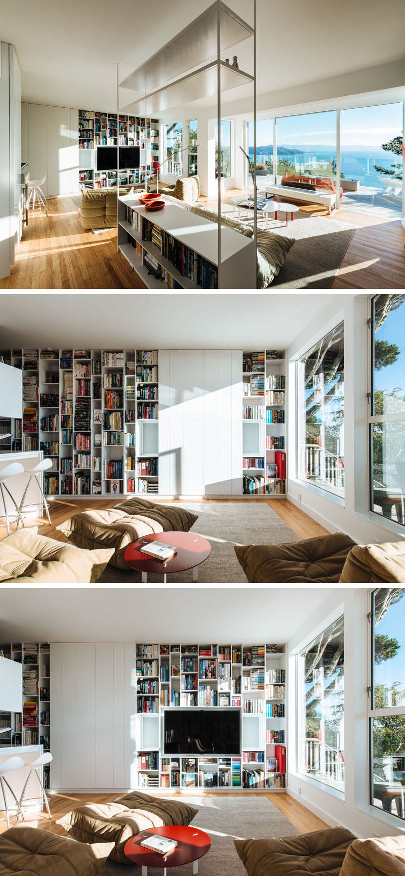 This modern home has a library that's filled with shelving and an open floor plan that takes advantage of the view. On one wall, floor-to-ceiling shelving has been added and the television when not in use, is hidden behind sliding white panels. #Shelving #HideTV #LivingRoom #Library