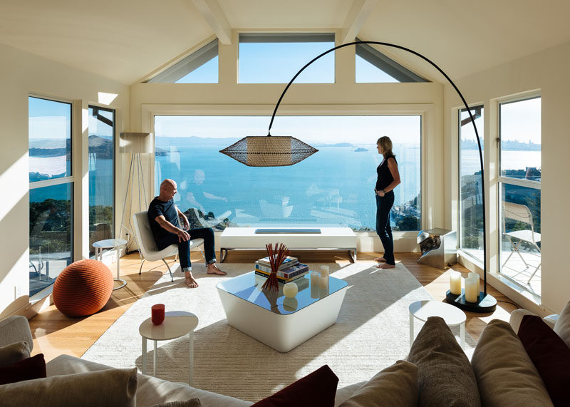 This modern living room has a large picture window that perfectly frames the water view. #LivingRoom #Windows