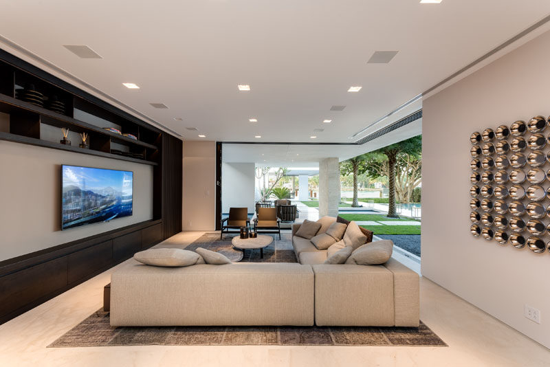 A modern living room with sliding glass doors that pocket and disappear, helping to blur the line between indoor and outdoor living.