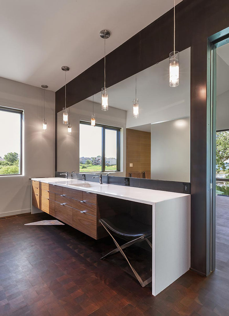 In this master bathroom, there's a large double sink white vanity that surrounds wood cabinets. #MasterBathroom #LargeVanity