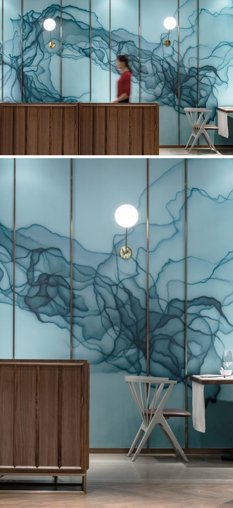 In this modern restaurant, there's an artistic wall that features an ink and dye pattern in shades of blue on embossed glass. #AccentWall #Blue #ModernRestaurant