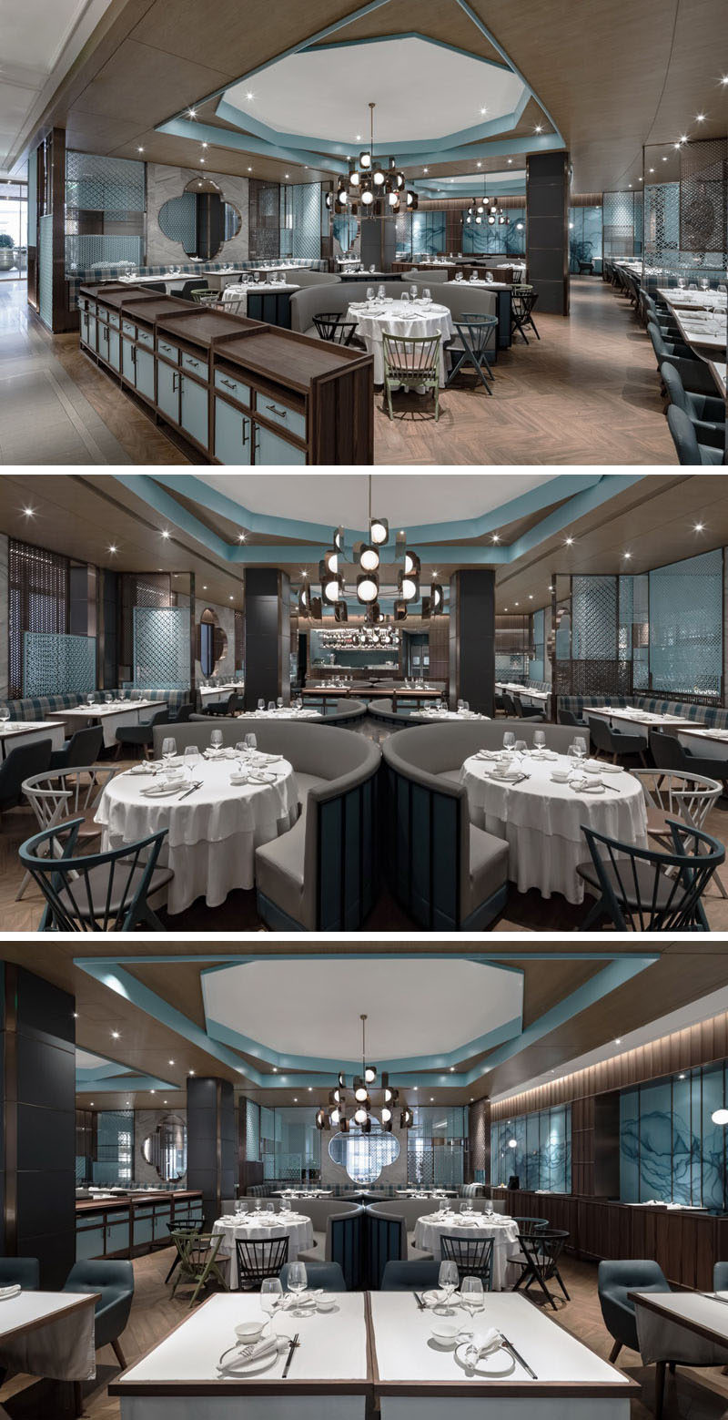 In the main dining area of this modern restaurant, a decagon ceiling feature and chandelier are positioned above curved seating booths. #RestaurantInterior #ModernRestaurant