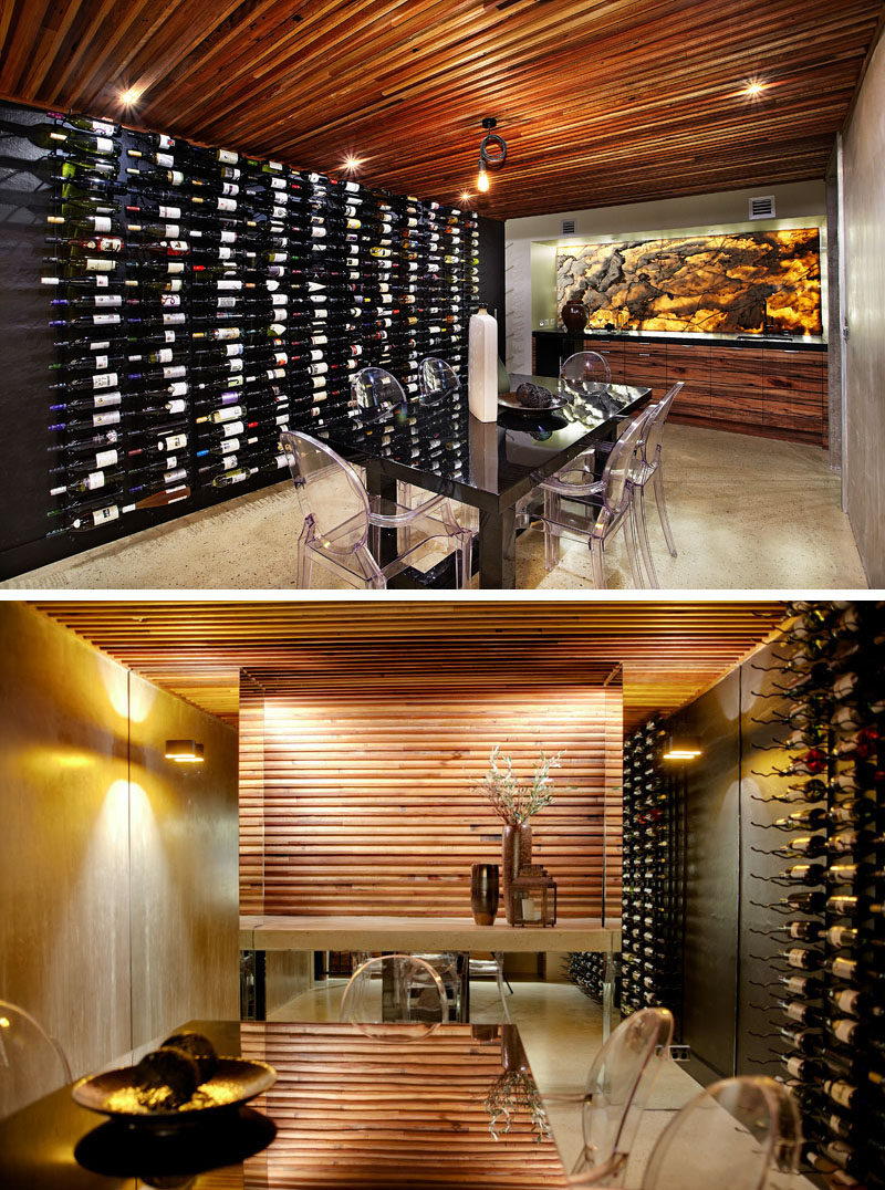 This modern house has a basement dining room cellar with a polished concrete floor, a curved re-claimed timber ceiling, mood lighting, floor-to-ceiling wine racks and a backlit onyx marble wall. #WineCellar #DiningRoom