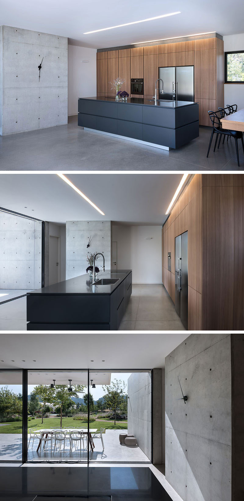 In this modern kitchen, minimalist wood cabinets line the wall, while a black island makes a statement. Next to the kitchen is a concrete wall adorned with a simple clock. #ModernKitchen #KitchenDesign