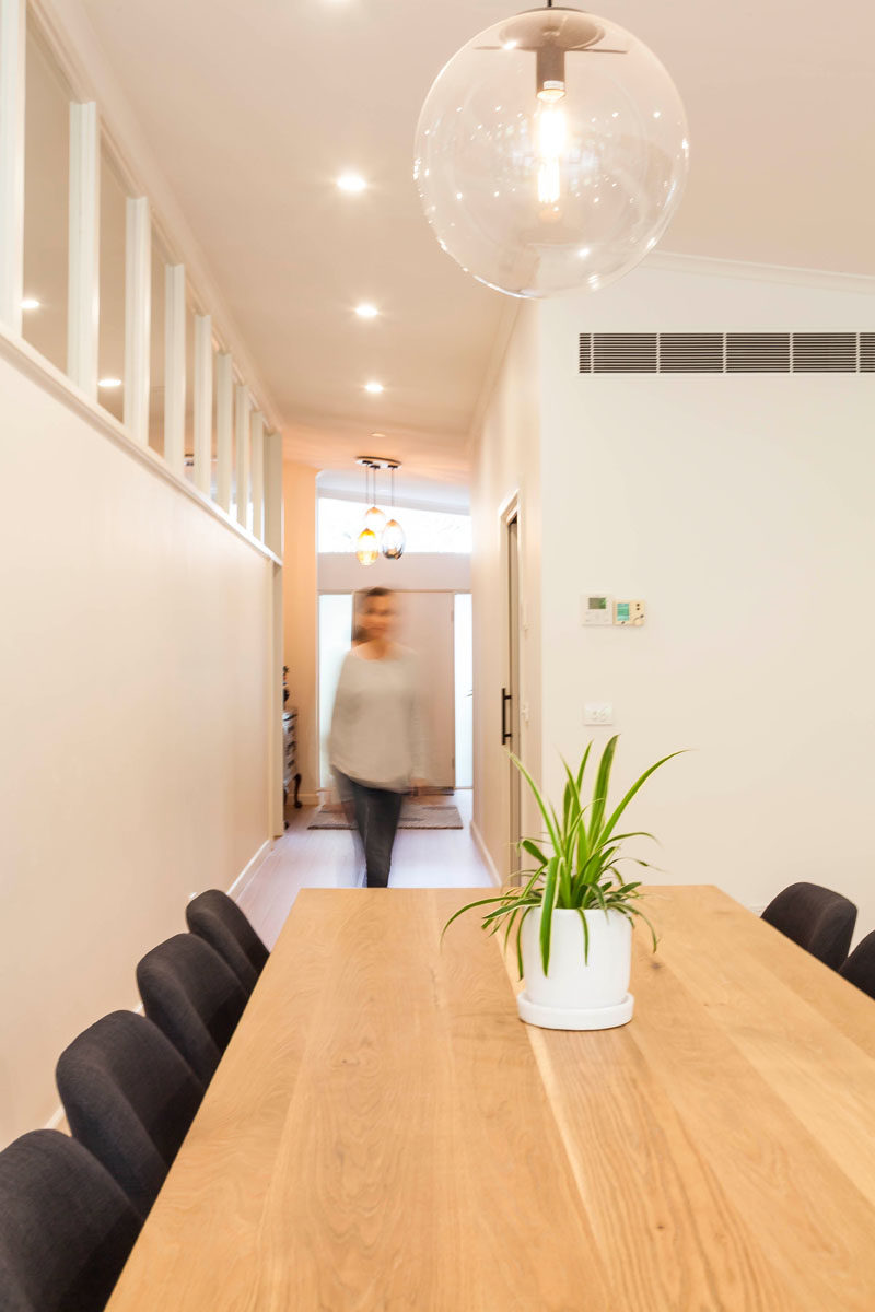 A large glass sphere pendant hangs above the dining area, defining the space in the open floor plan. #DiningArea