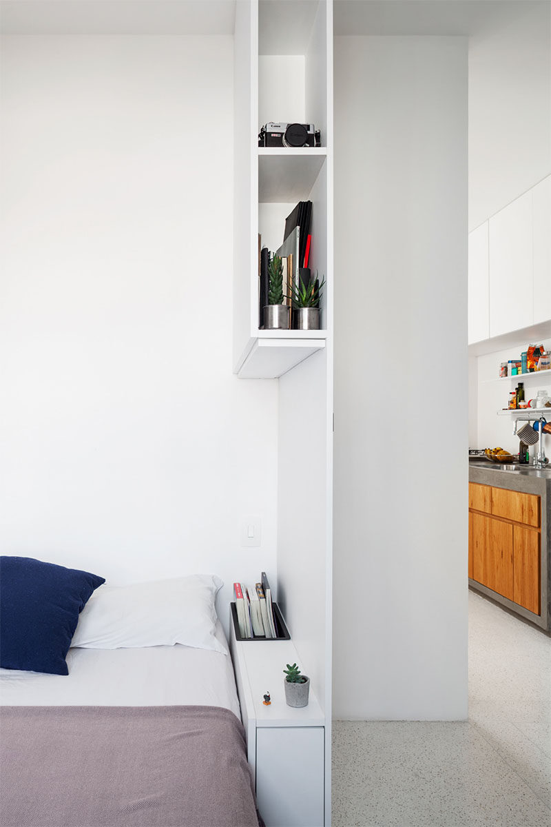 Simple shelving in this modern bedroom provides extra storage, and acts as a bedside table and privacy wall. #Bedroom #Shelving