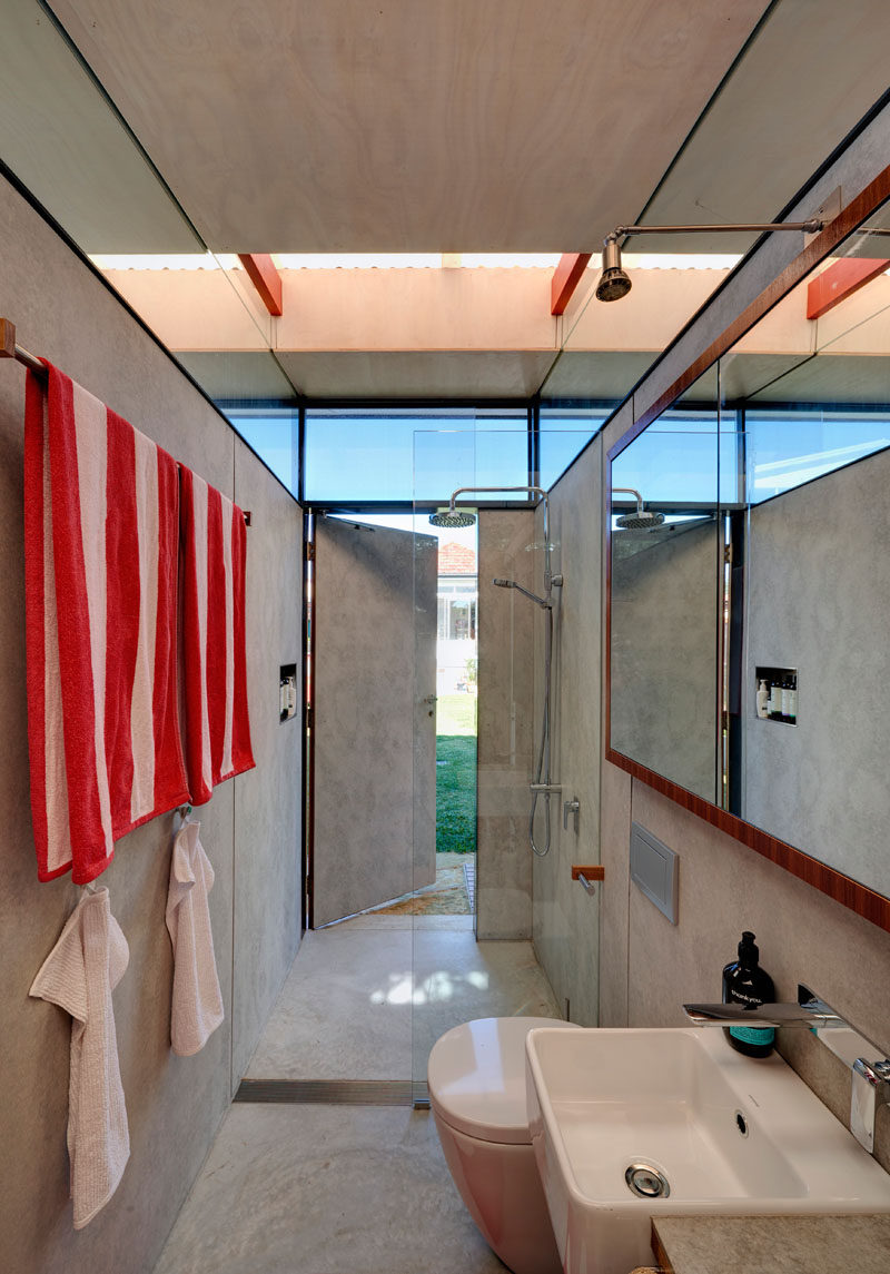 This modern backyard studio in Australia has a home office, living quarters, bathroom with laundry, an outdoor shower and a shed with an indoor/outdoor workspace. #BackyardStudio #GuestHouse #Bathroom