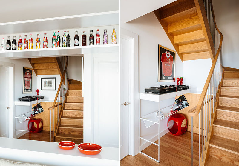 Wood stairs connect the different floors of this home, and at the bottom of the stairs, is a small music area with a couple of turntables. #RecordPlayer #InteriorDesign #WoodStairs