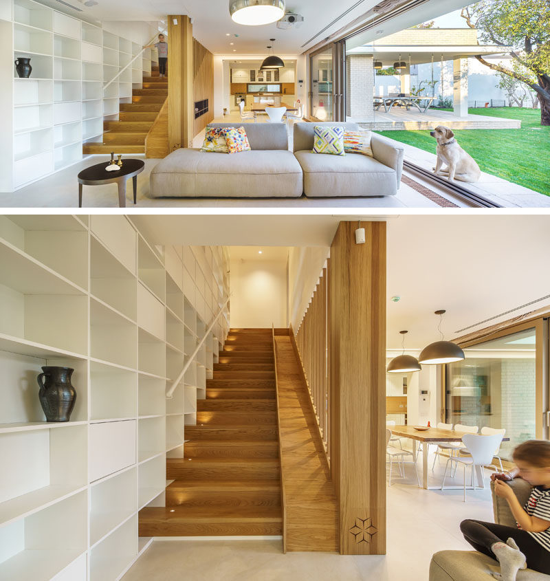 This modern house has wood stairs with a built-in slide for the kids in the family. #WoodStairs #ModernStairs #Slide