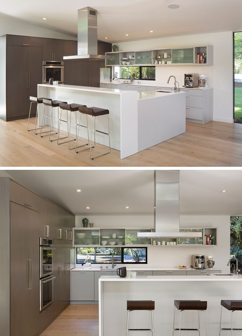 This modern kitchen has plenty of storage and the L-shaped island has a bar area with seating. #KitchenDesign #ModernKitchen