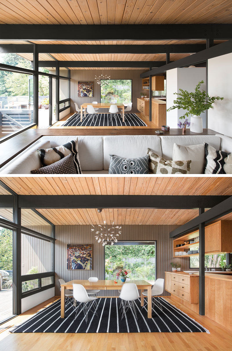 This mid-century modern interior has a dining area that's defined by the use of a large rug and a chandelier. #DiningRoom #MidCenturyModern