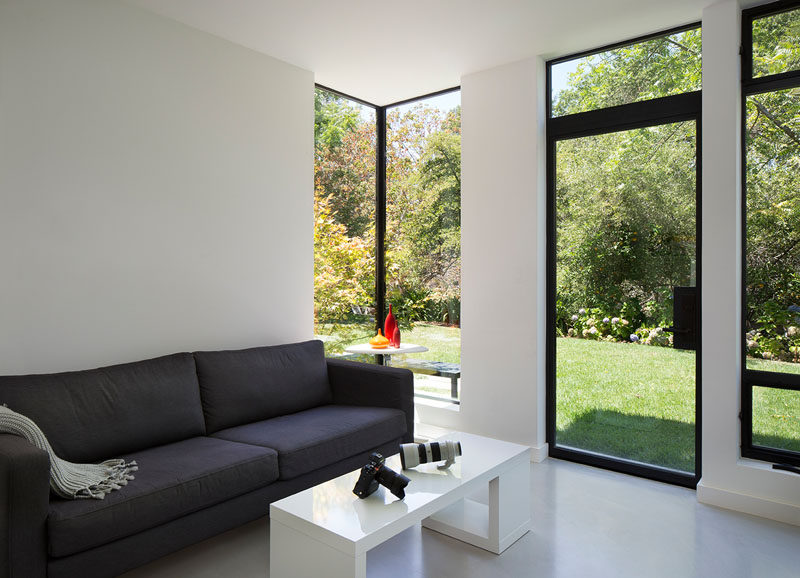 This family room has white polished concrete floors with radiant heating to allow the family to seamlessly move barefoot from inside to outside. #WhiteConcreteFloor #PolishedConcreteFloor #FamilyRoom