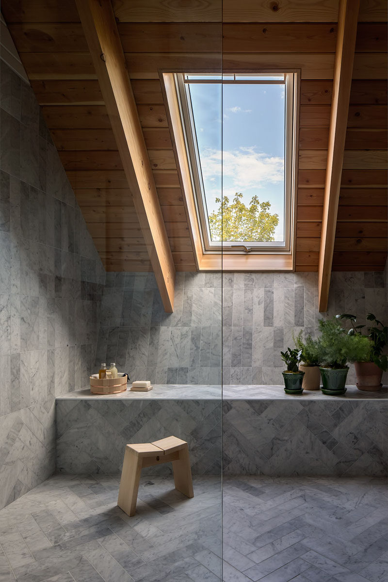 This modern bathroom has a window for views of the treetops and a Douglas fir ceiling brings a natural element inside. #Bathroom #GreyTile #Window