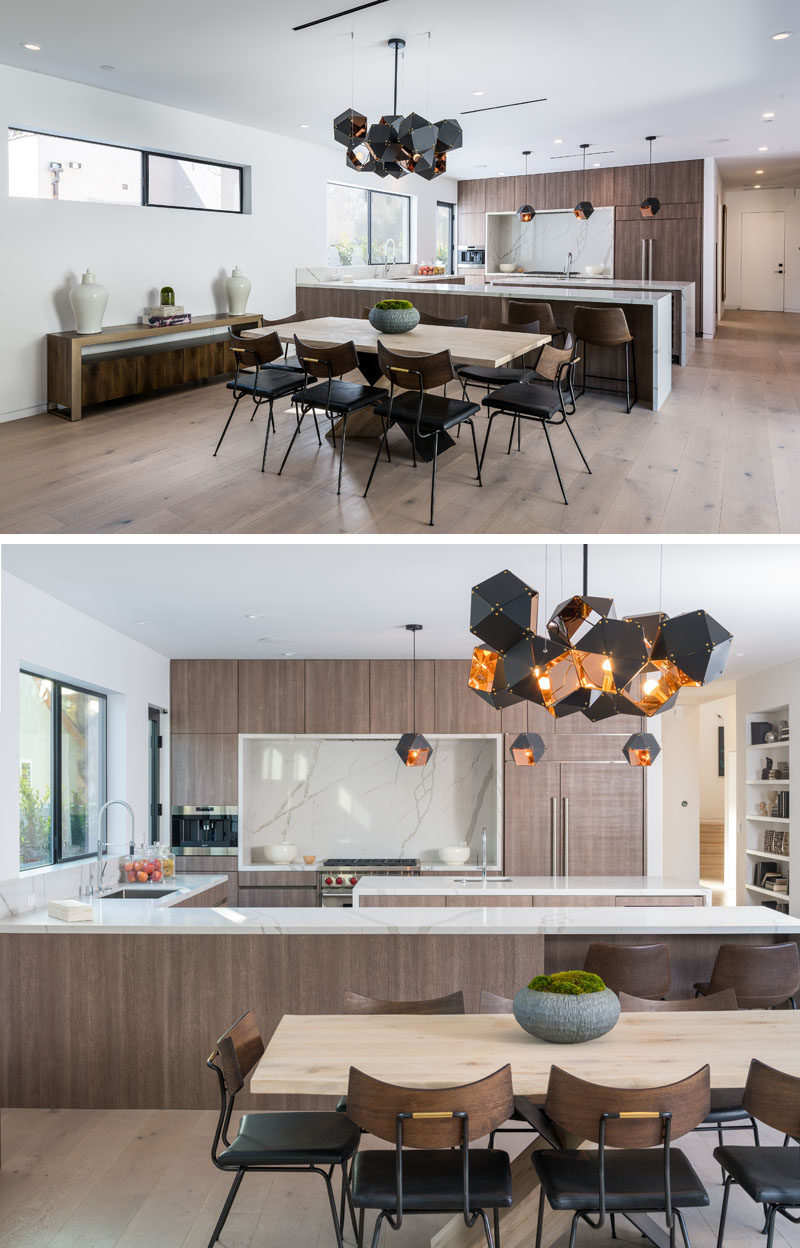 A modern and geometric chandelier sits above the dining table and anchors it in the large open plan room. #DiningRoom #Lighting