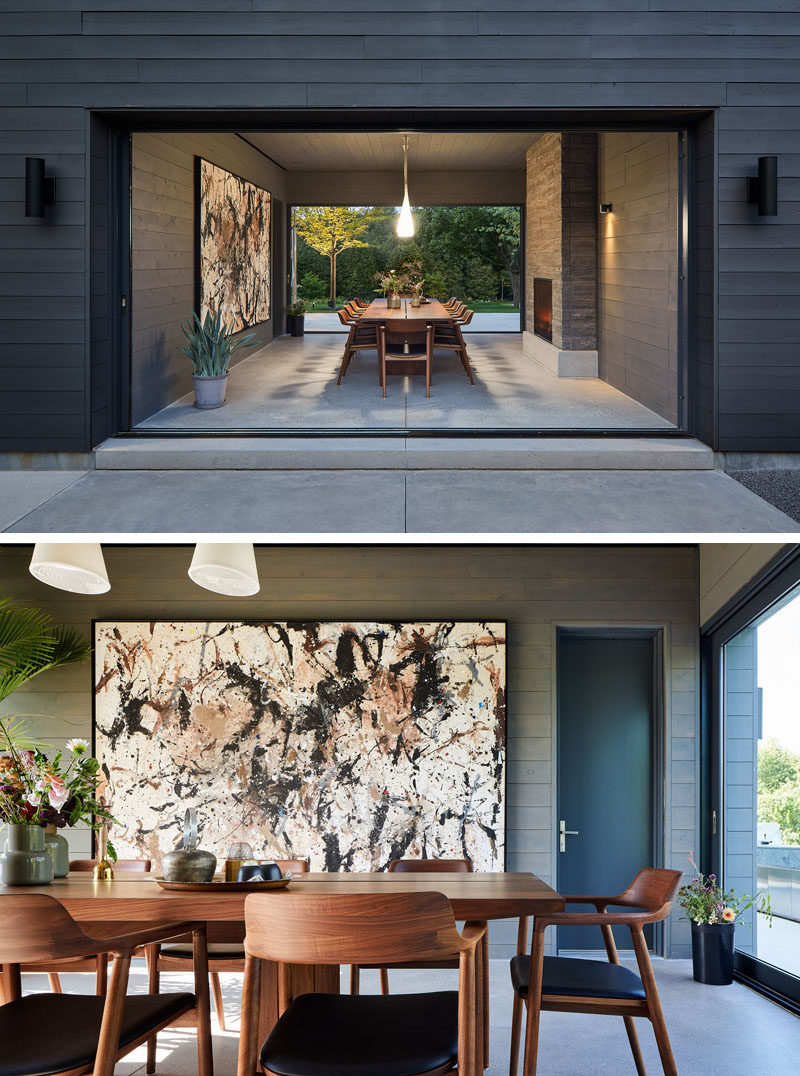 Sliding glass pocket doors on either end of this dining room can be opened to the outdoor spaces, and when it's cooler, they can be closed to enjoy the warmth of the fireplace. #DiningRoom #PocketDoors