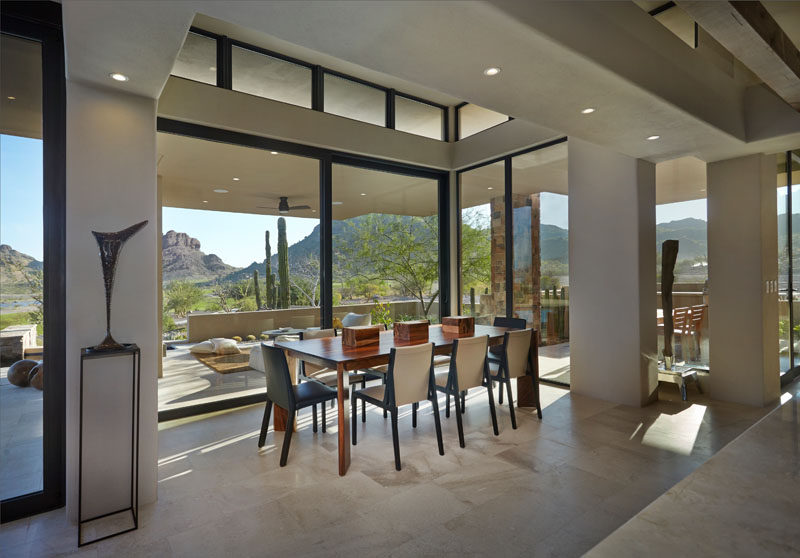 This contemporary dining room features wide glass panes that perfectly show off the view. #Windows #DiningRoom