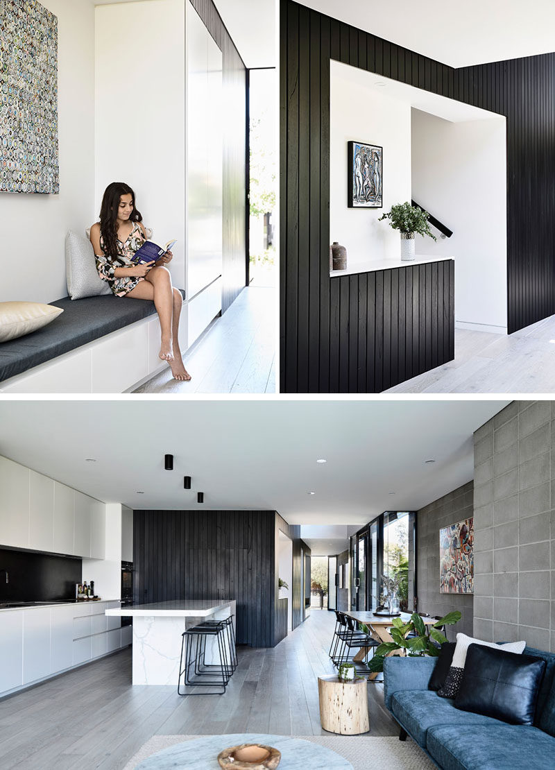 This modern house has the entryway defined by black stained time cladding, that wraps around a built-in bench and the stairs, and then travels through to the kitchen.