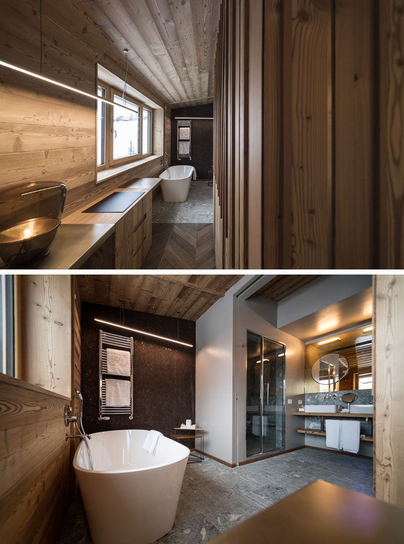 A small hallway off the bedroom opens up to a modern bathroom. In the bathroom, there's a freestanding bathtub and an enclosed shower. #ModernBathroom #BathroomDesign