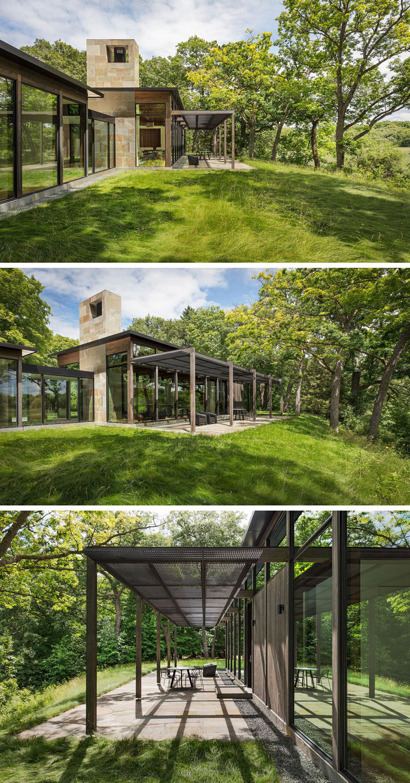 This modern house has a covered patio with views of the surrounding landscape. #CoveredPatio #ModernHouse #OutdoorSpace