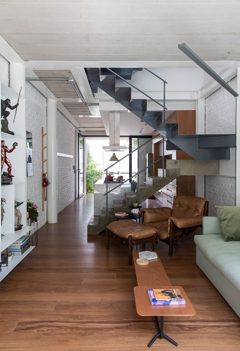 The stairs in this narrow modern home combine concrete and steel for a slight industrial look. #Stairs #StairDesign