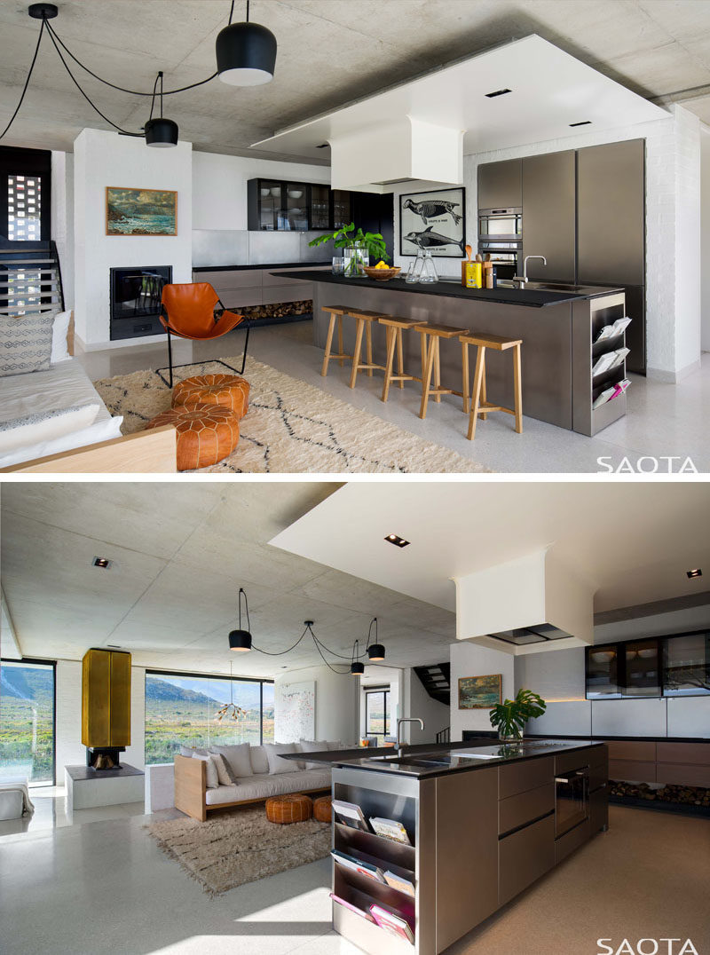 In this modern kitchen, a long island has enough room to seat five people, and at one end of the island, there's a small bookshelf / magazine rack. #KitchenDesign #ModernKitchen