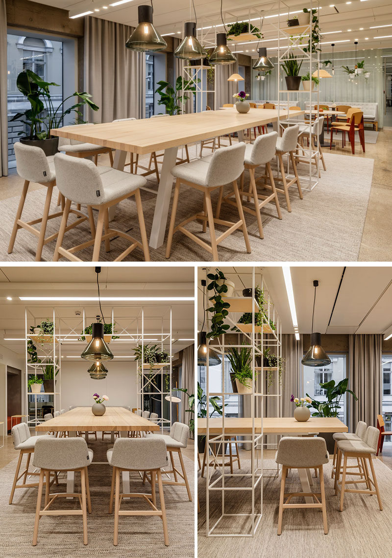 This modern office has long communal bar-like tables and smaller dining tables give the employees a place to relax while they eat their lunches. #ModernOffice #Workplace #Dining