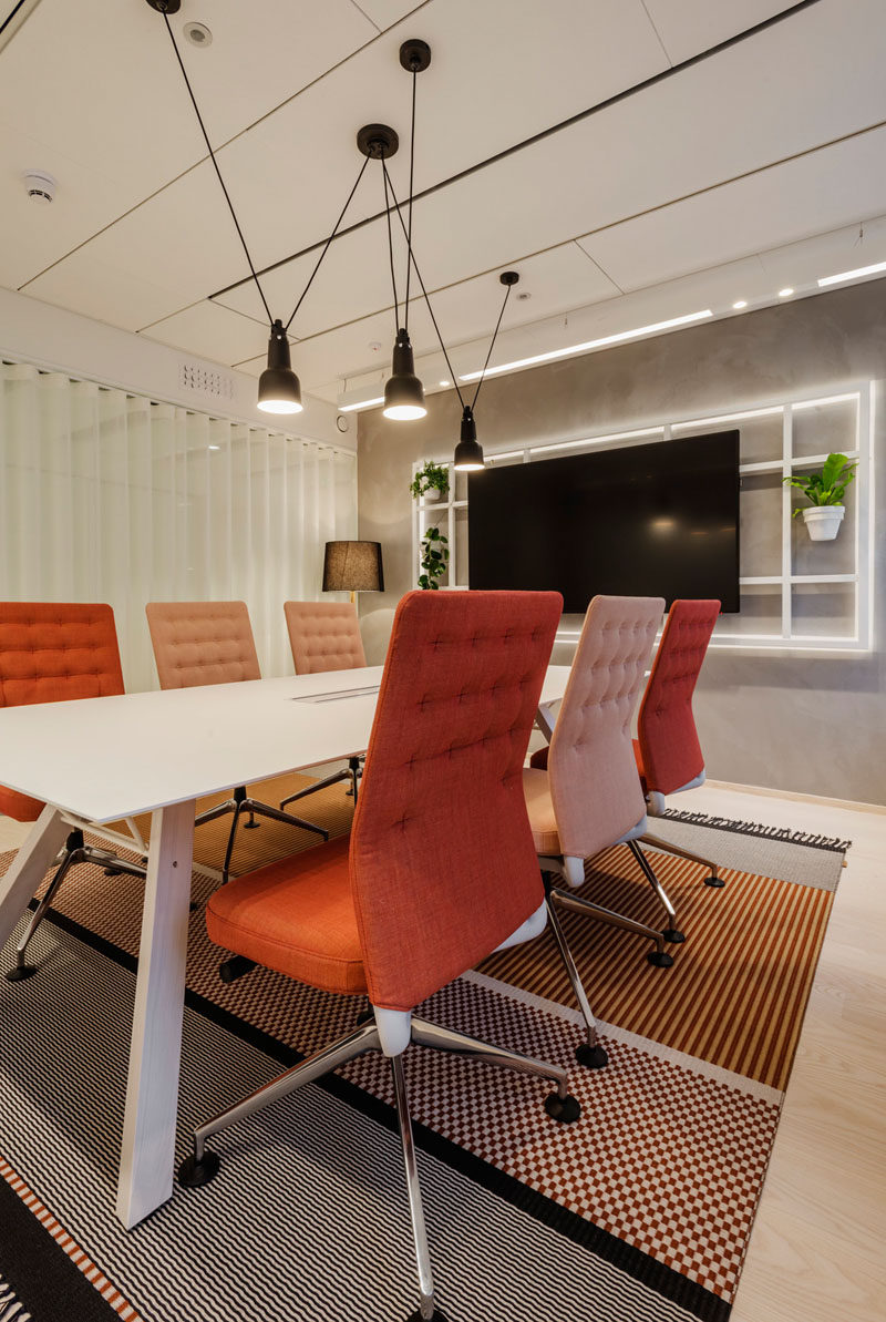This modern meeting room has desk chairs that are upholstered to complement the rug. #MeetingRoom #Workplace