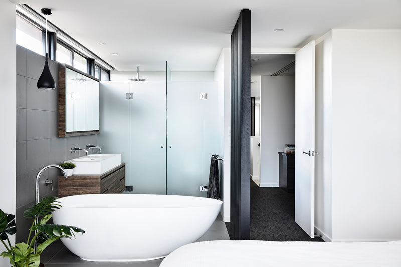 In this modern bedroom, the bathroom is located within the room and is open, with only the shower and toilet behind closed doors. #Bathroom #ModdernBedroom