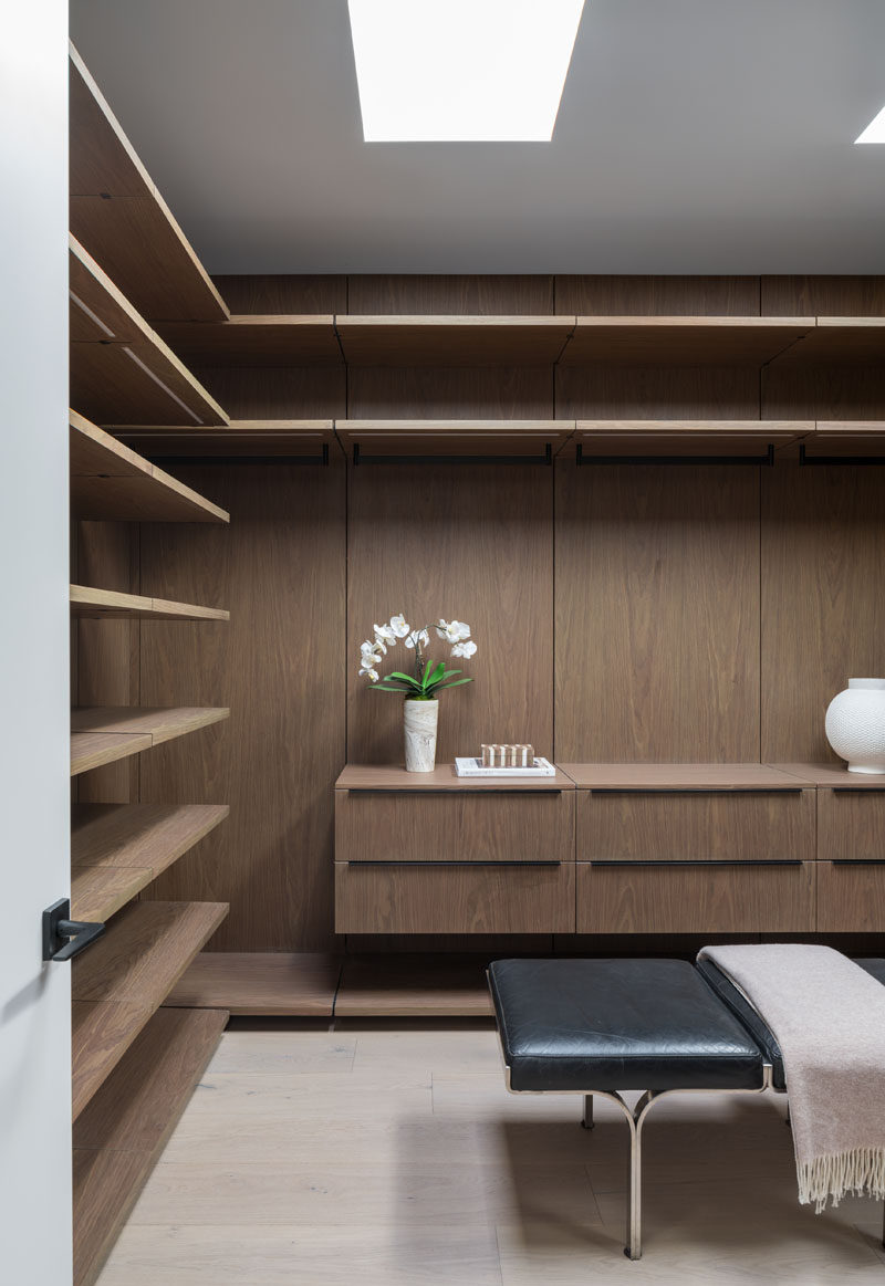 This modern walk-in closet has plenty of space to hang, display and put away clothes. #WalkInCloset