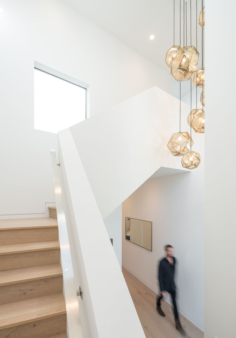 Wood and white stairs lead to the upper floor of this modern house. #Stairs #StairDesign