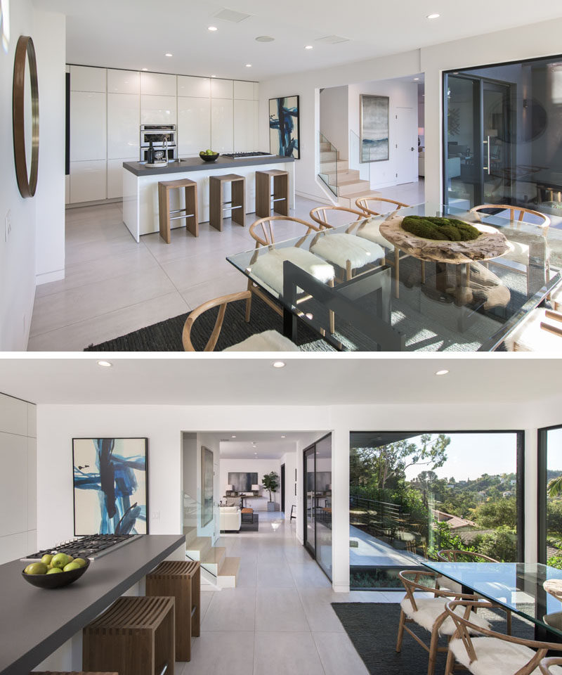 In this kitchen, minimalist floor-to-ceiling white cabinets have been combined with a grey countertop for a clean contemporary look. #Kitchen #ModernKitchen