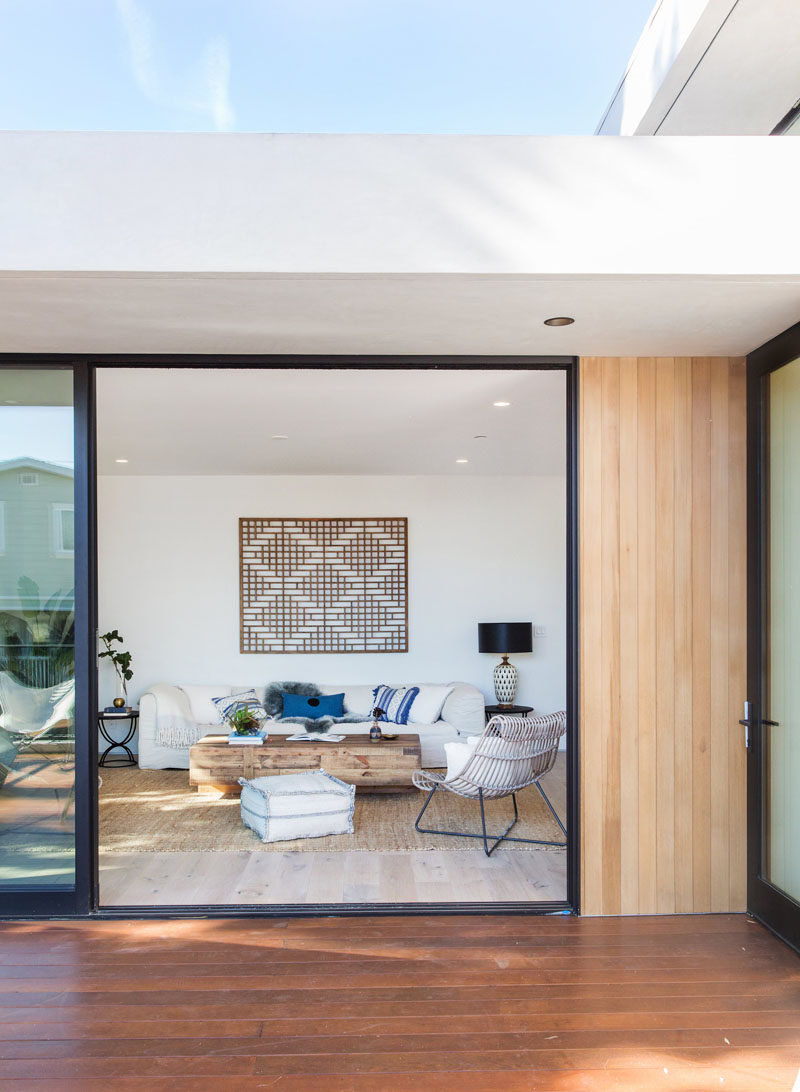 This living room opens up to a wood deck that's located on the corner of the house. #InteriorDesign