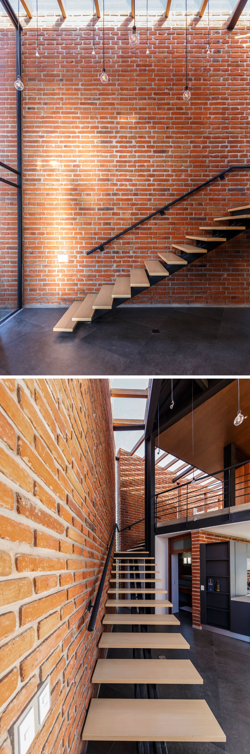 This modern house has wood stairs that run alongside a brick wall, while a skylight adds natural light to the space. #BrickWall #ModernStairs #Skylight