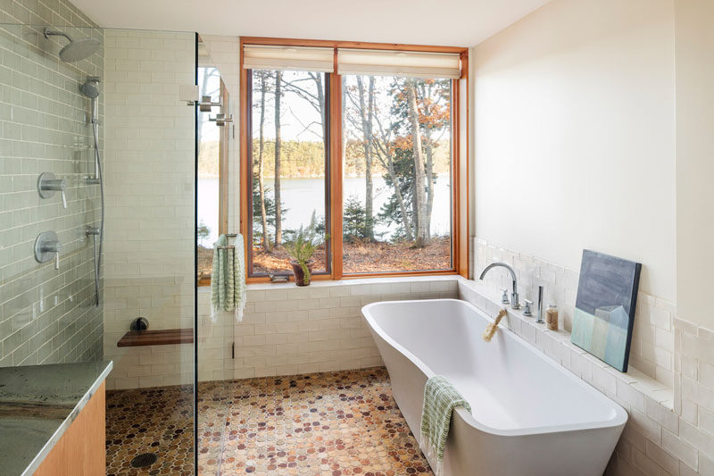 In this master bedroom, the bath is positioned to take advantage of the views. A walk-in shower with a glass surround helps to keep the bathroom feeling open and bright. #MasterBathroo #BathroomDesign