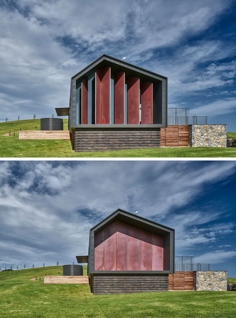 This modern Australian guest house has six full height copper louvre panels that can be closed at the touch of a button to control of solar heat gain, views and light. Click through to see more photos of this guest house. #Windows #LivingRoom #Fireplace #GuestHouse #Architecture