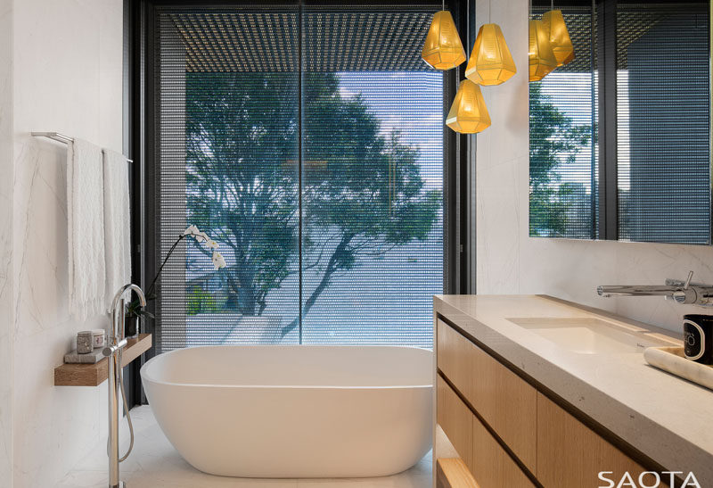 In this modern bathroom, the freestanding bathtub sits next to the window and has harbour views. #ModernBathroom #BathroomDesign