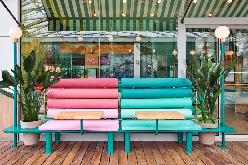 Colorful benches with bright cushions and planters sit outside this modern Italian restaurant. Click through to see more photos. #Seating #RestaurantDesgin #OutdoorSeating