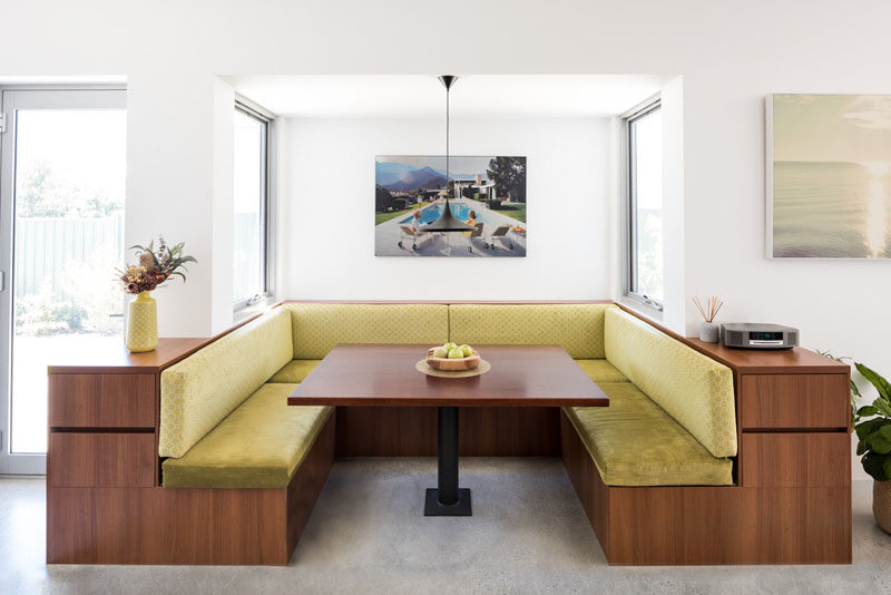 Drawing from mid-century design and American Diner styled breakfast booths, a custom booth was created this modern house, that acts as a natural hub for the family. #DiningBooth #ModernDining